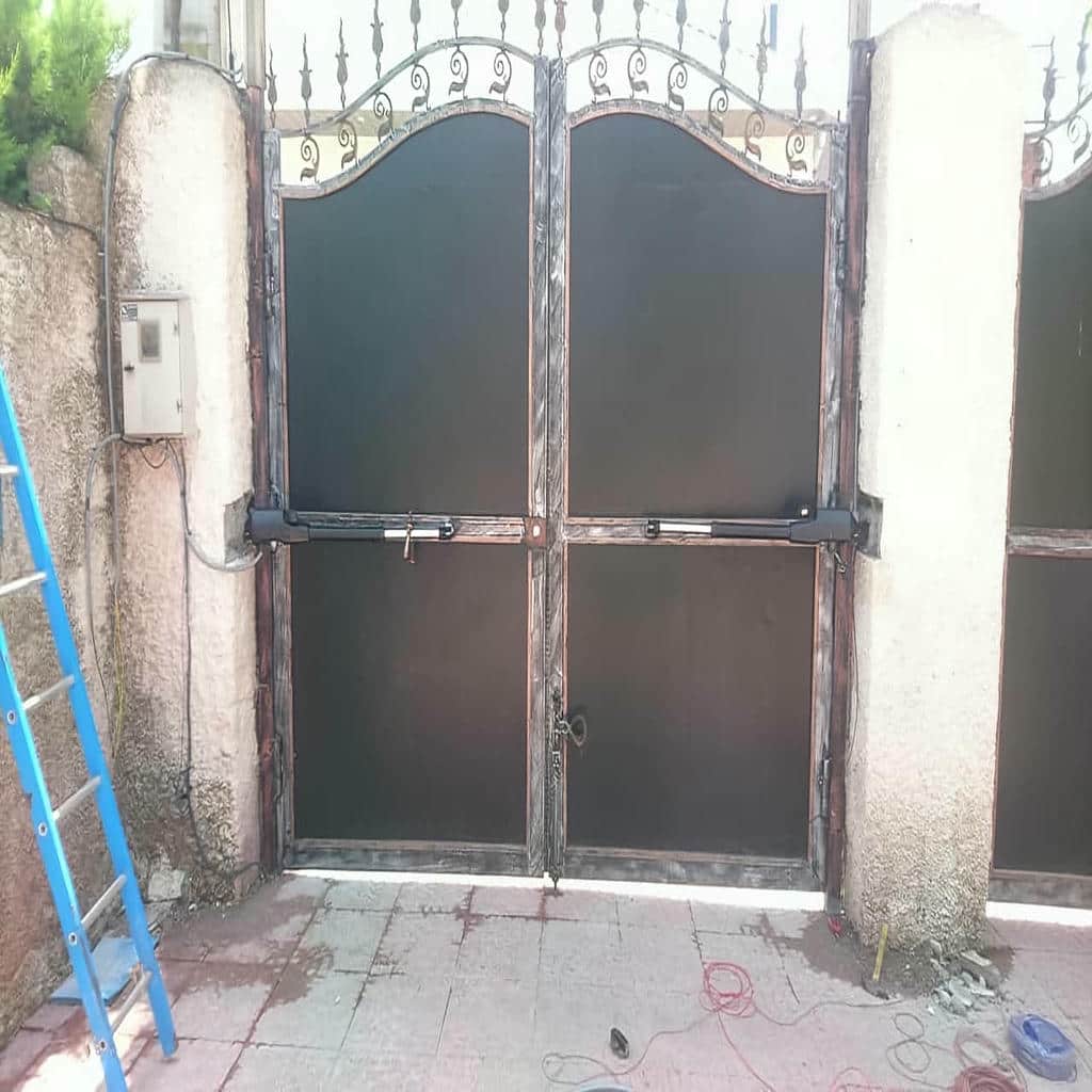 جک درب پارکینگ با بدنه خاکستری روی درب سنگین